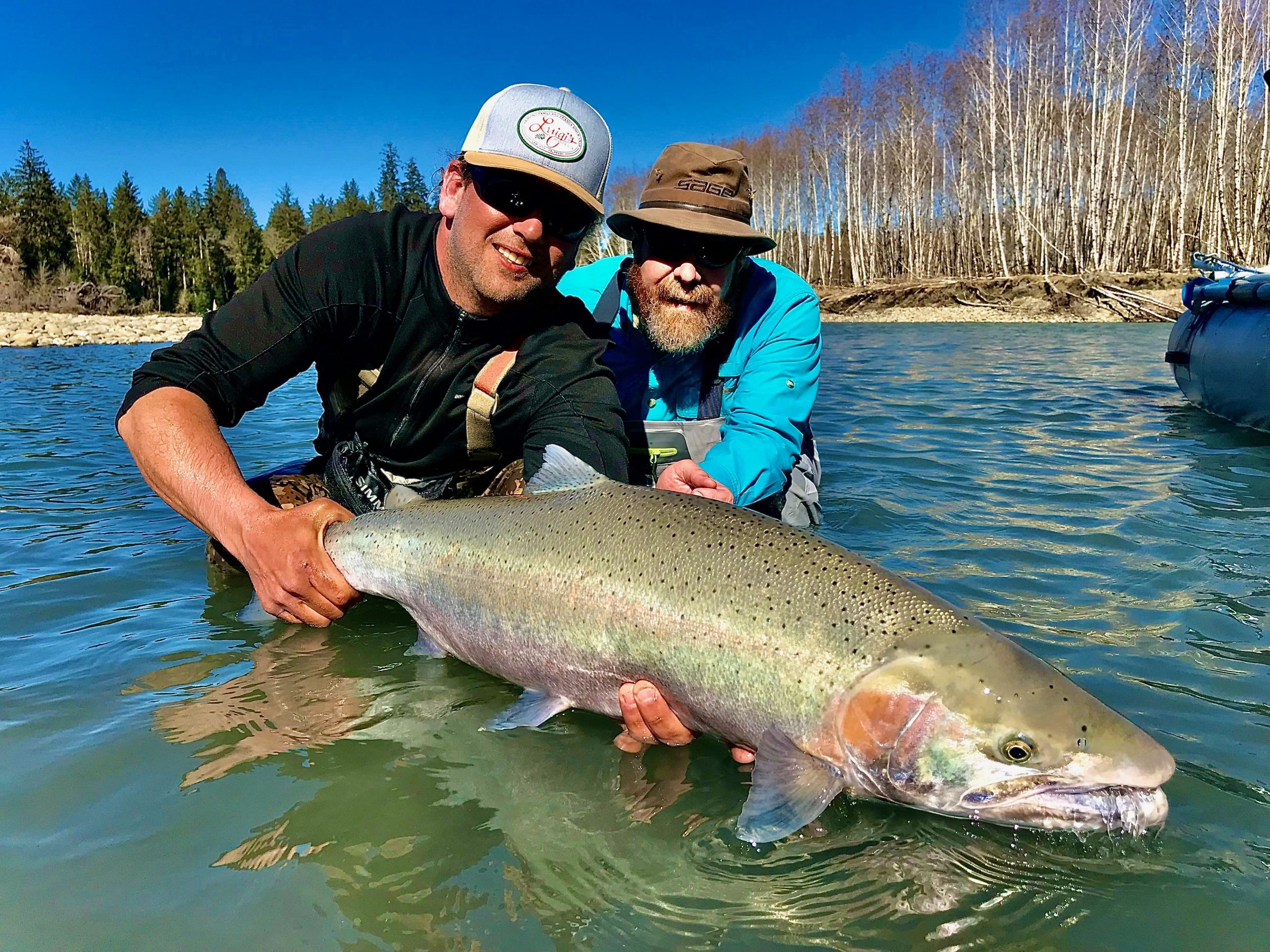Guide and angler with a Montana trout near the boat